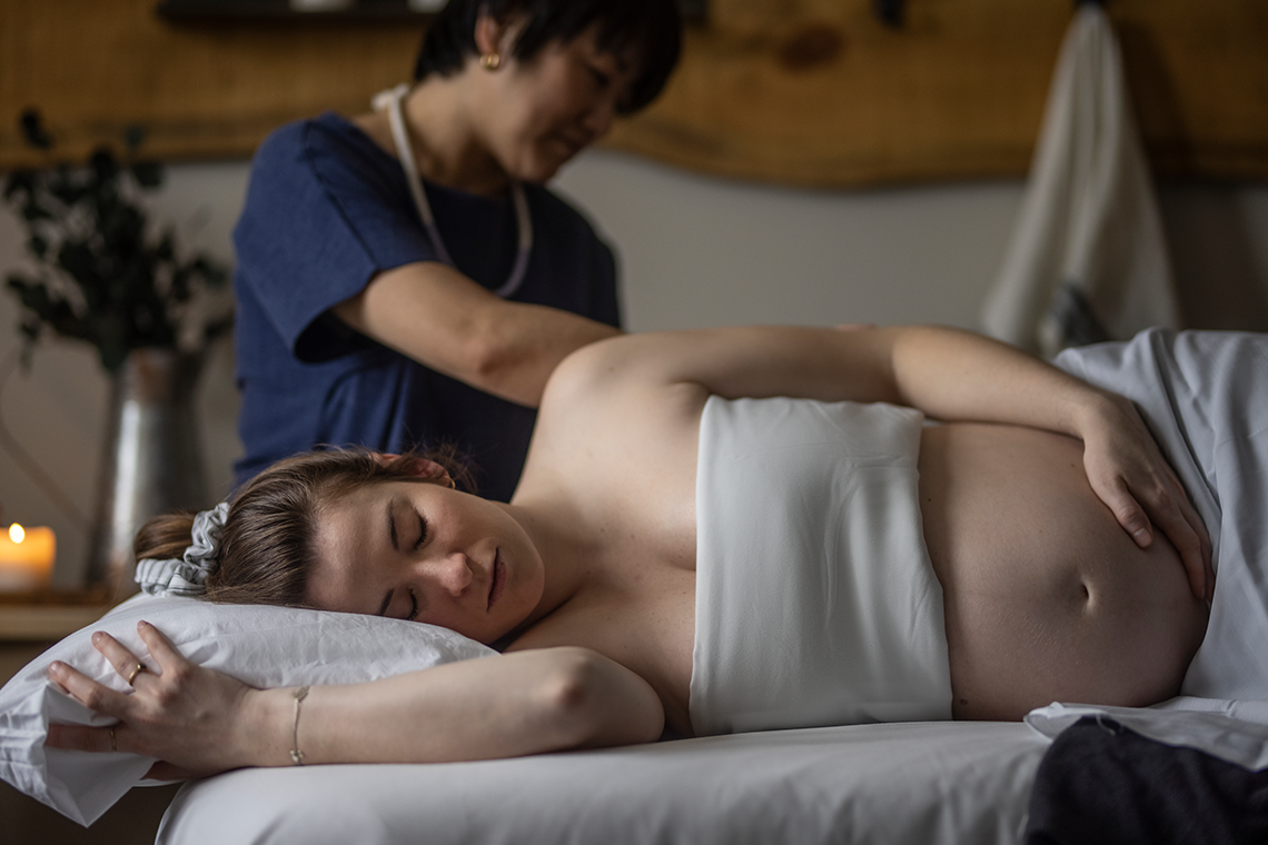 woman receiving a mom-to-be massage