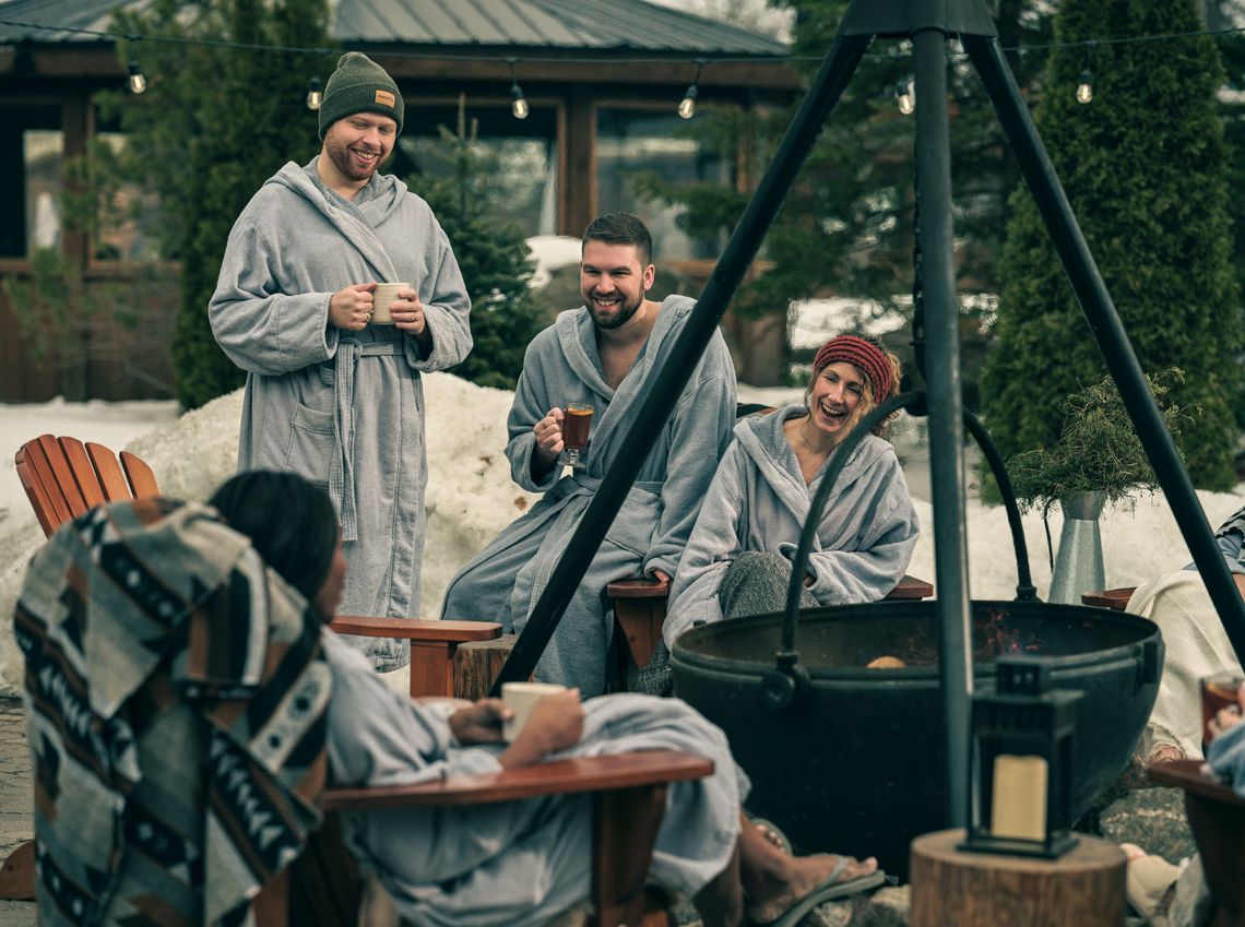 guests enjoying drinks next to an outdoor fire