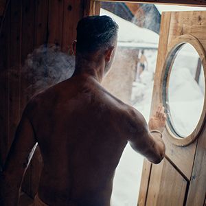 man exiting a steamy sauna