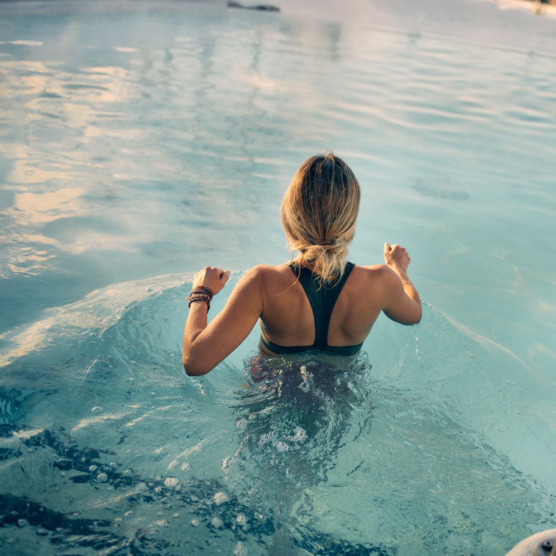 woman entering a bath during winter