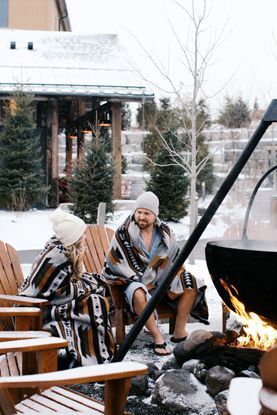 couple by an outdoor fire in winter