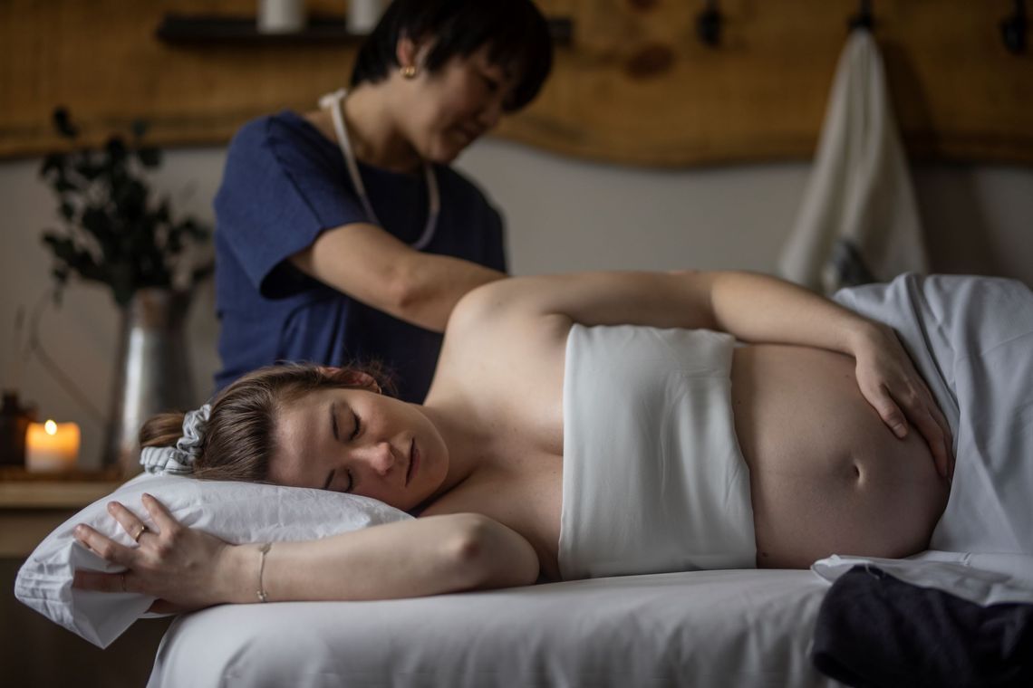 pregnant woman receiving a massage
