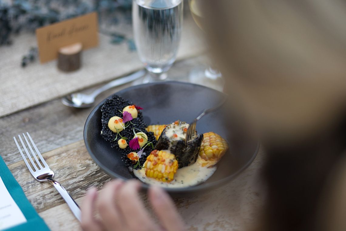 black garlic halibut on a sweet corn purée, beurre blanc with trout roe and chives, and parsnips