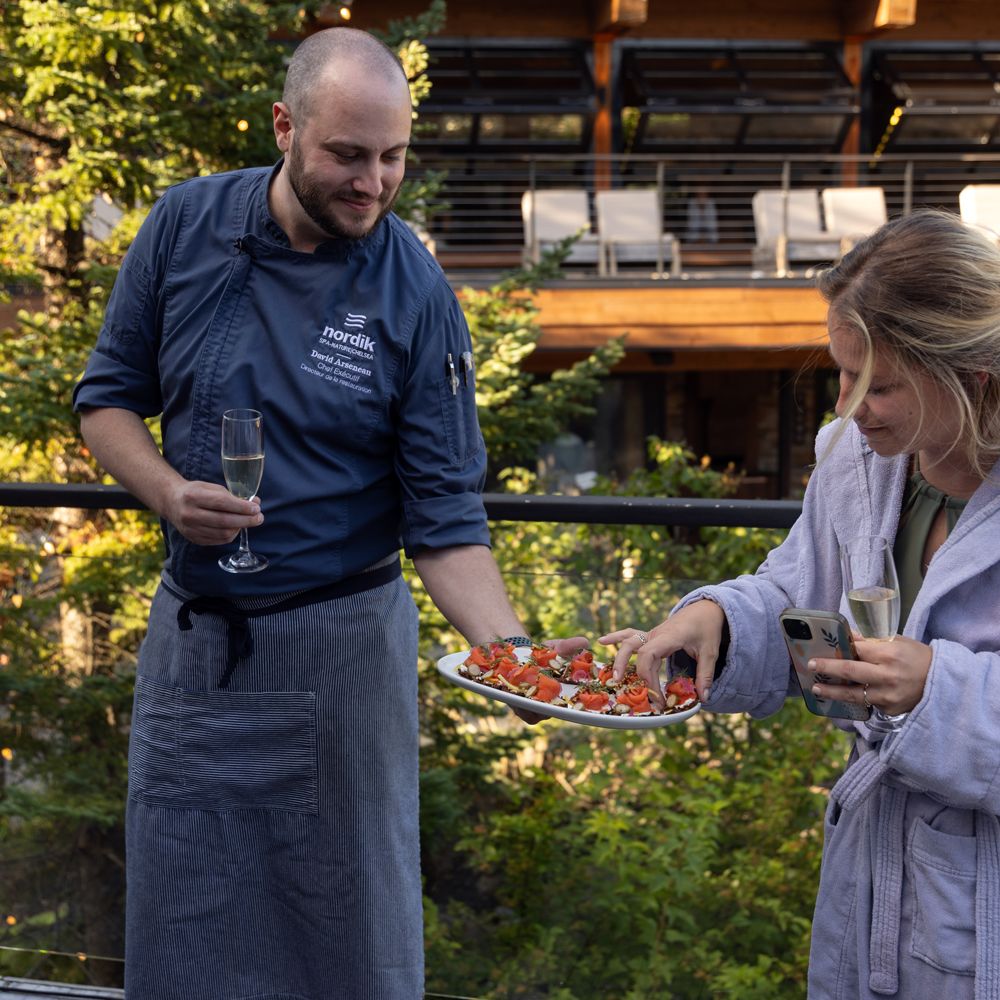 Chef David offering a bite to Karol-Ann