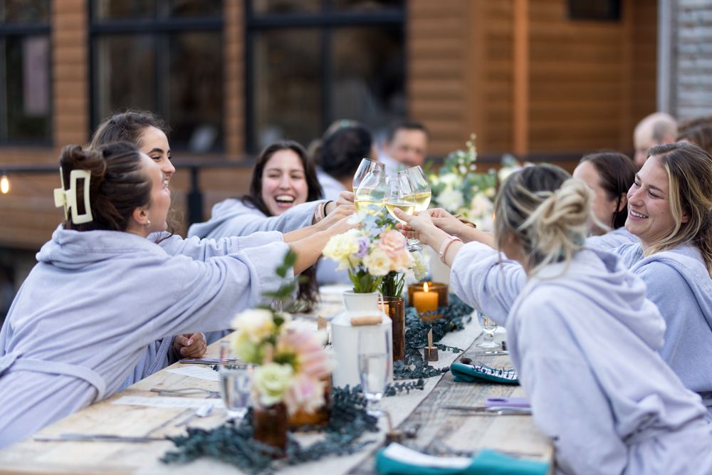 guests around the table holding their glasses up for a cheer