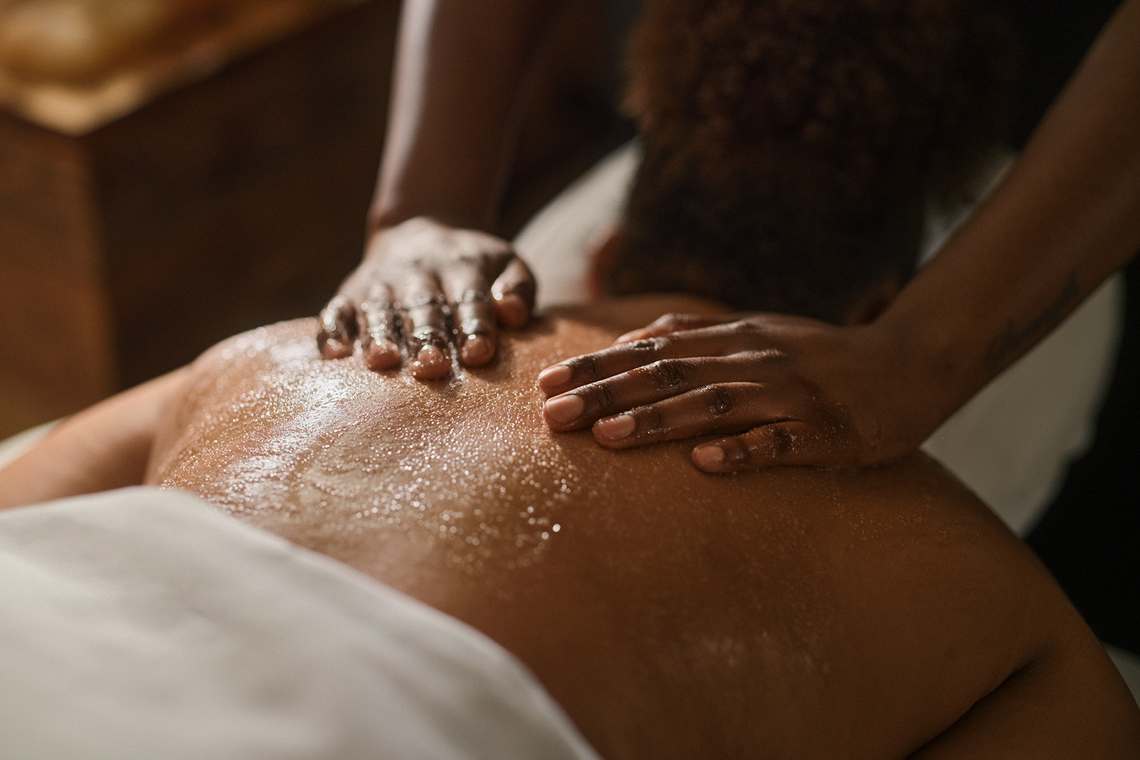 woman enjoying a himalayan salt stone treatment