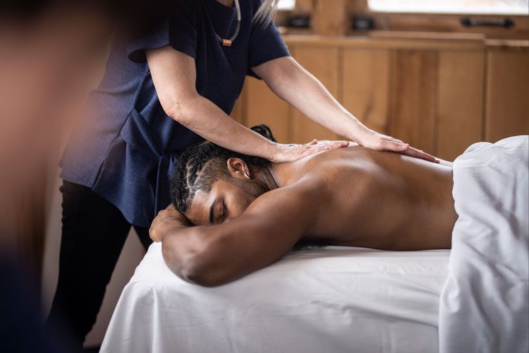 man enjoying a massage in nature