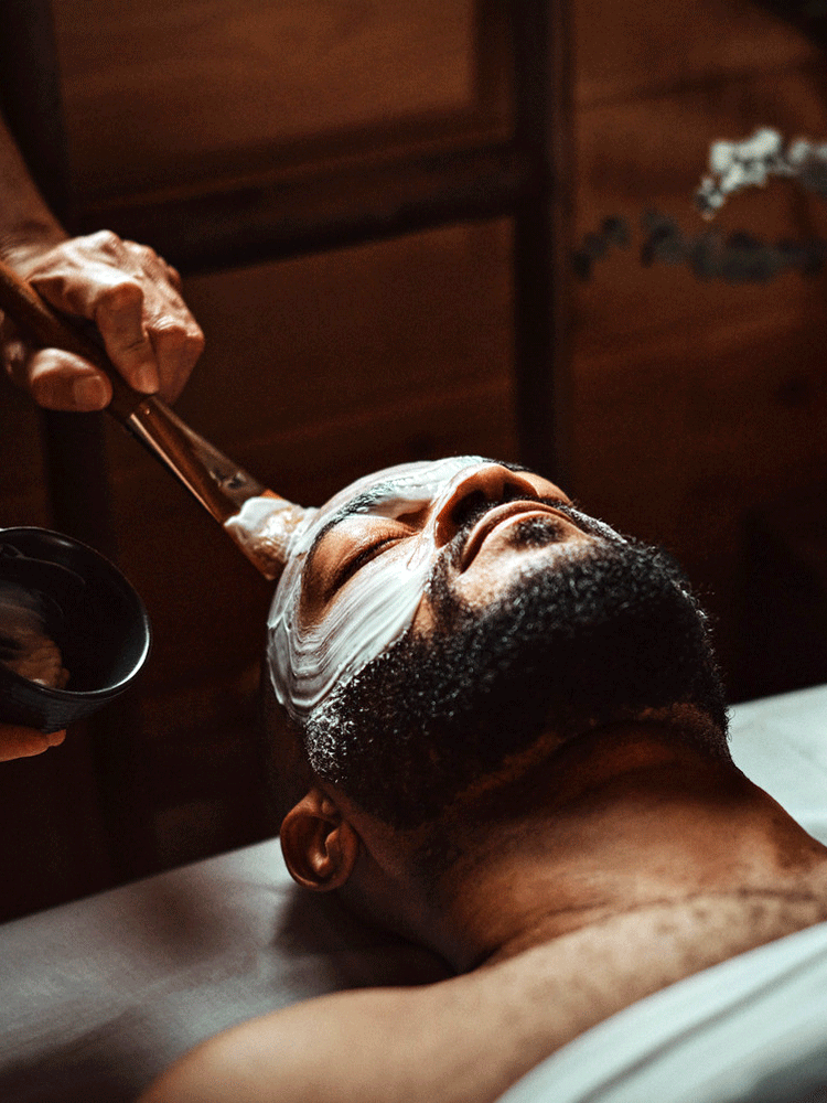 man receiving a face care treatment