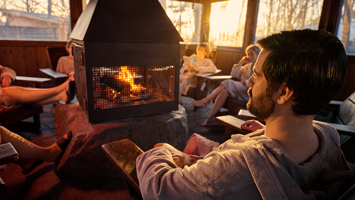 Guests relaxing around a fireplace