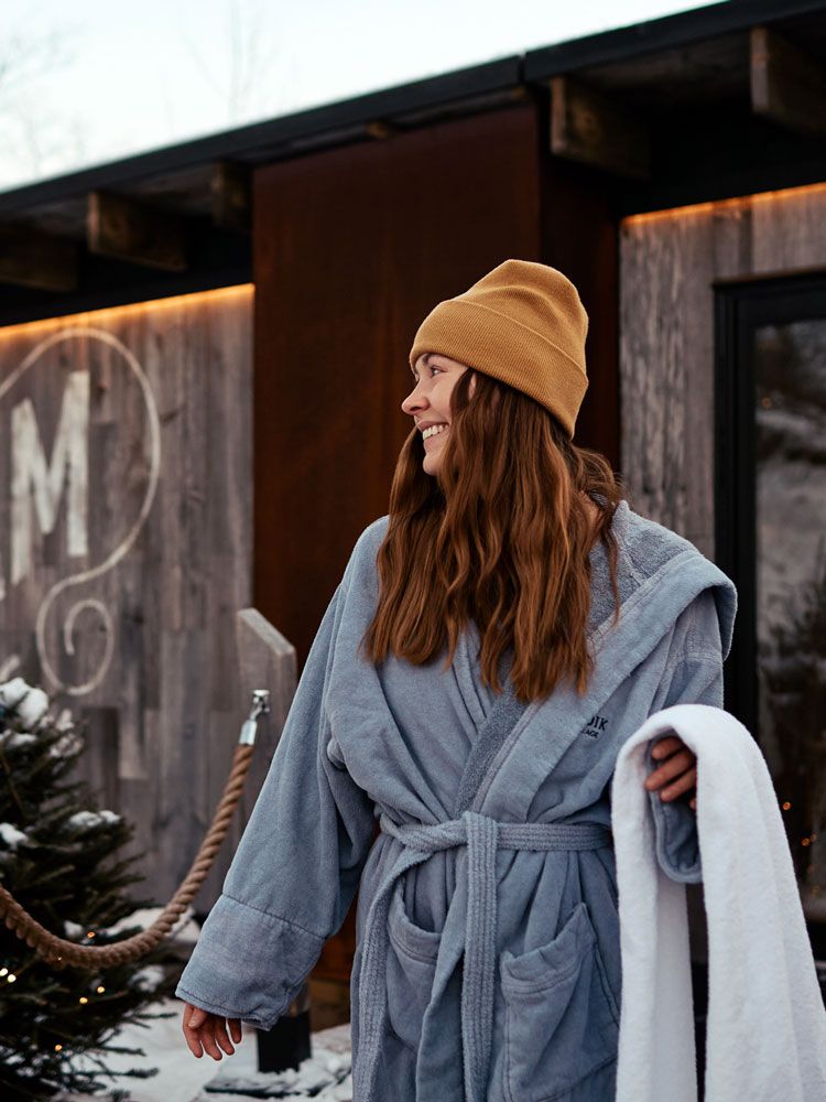 woman walking out of a steam sauna