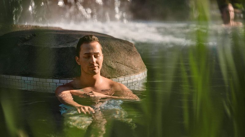 man relaxing in a hot bath at the spa