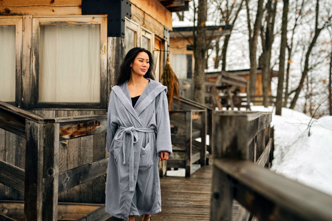 woman exiting an outdoor cabin