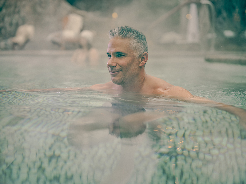 man relaxing in a thermal bath