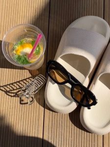 sandals, sunglasses and a drink on a patio