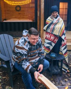 people near a fire wearing MINI TIPI merchandise