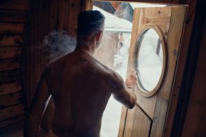 man exiting a sauna in winter