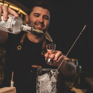 man pouring some Gin