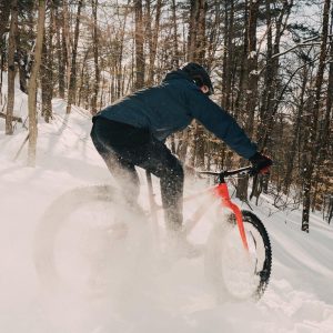 person doing fatbike in the snow